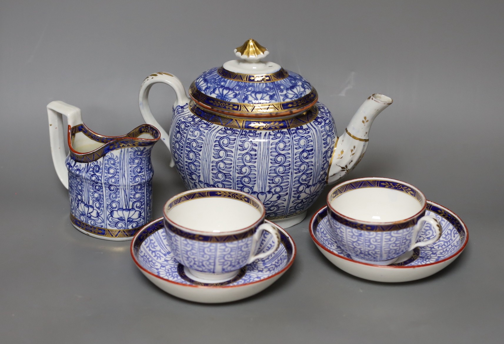 Two Worcester Royal Lily cups and saucers, a cream jug and a teapot- 18 cms high including lid